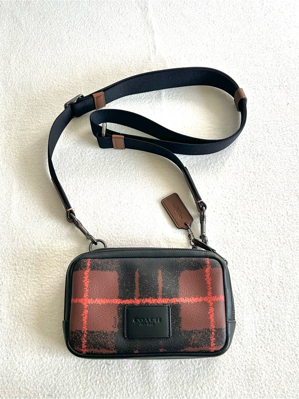 COACH CARRIER PHONE CROSSBODY WITH PLAID PRINT in REDDISH ORANGE AND BLACK